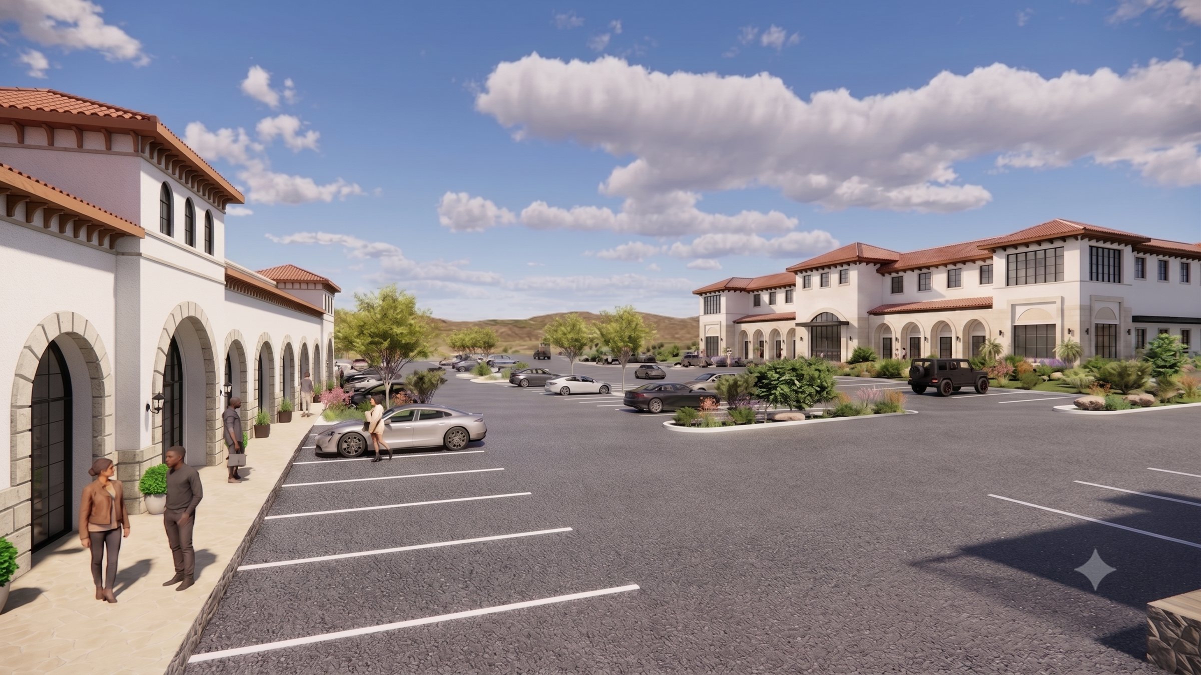 Jardines at Cimarron campus with Spanish Revival buildings, arched arcades and mountain backdrop